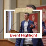 Professional photo of UWEBC keynote speaker Jeff Toister on stage with his hand outstretched.